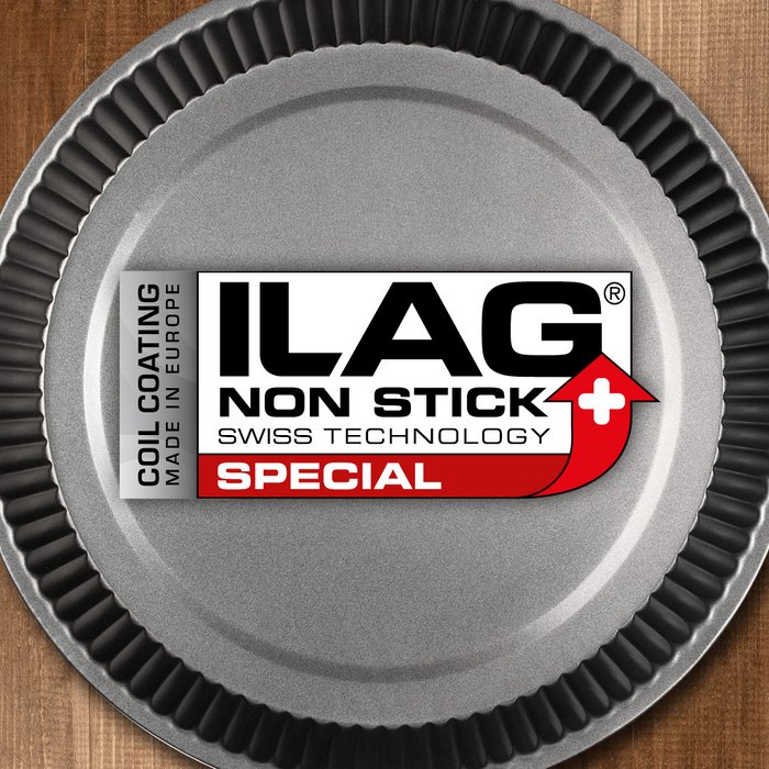 Anthracite coated inside of a round baking tray with wavy edge - ILAG logo with red shaded Special lettering in the center and on the left hand side an extra labeling "Coil Coating-Made in Europe"