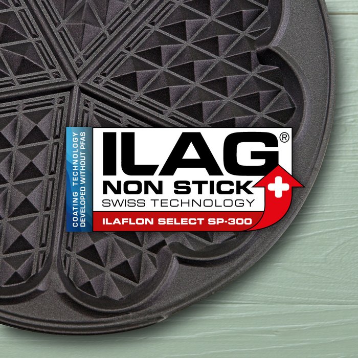 Schwarz beschichtetes Eisen für Herz-Waffeln - mittig das ILAG Logo mit rot unterlegtem Ilaflon Select SP-300 Schriftzug und links zusätzlicher Beschriftung "PFAS-free" in blau